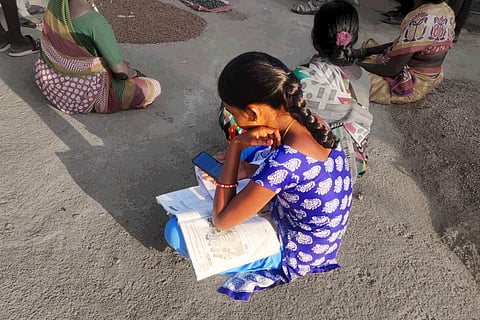A girl sitting with books in her lap