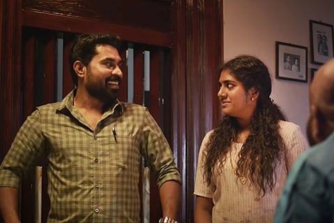 Suraj Venjaramoodu and Nimisha Sajayan looking at each other in The Great Indian Kitchen