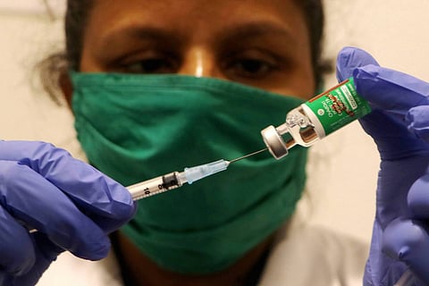 Health worker taking vaccine from a vial