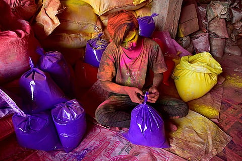 A worker packing colours
