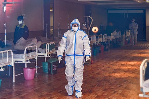A medical professional in a PPE suit
