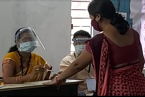 A voter getting inked before voting