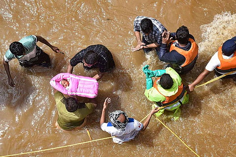 Photo of a baby being rescued from floods in Hyderabad 