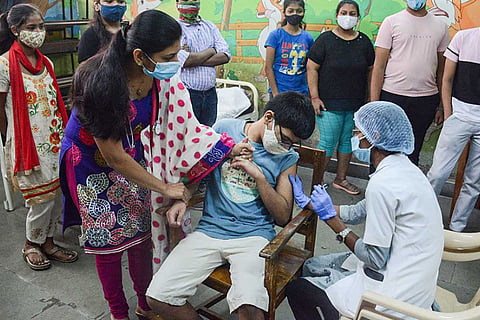Representative image of a teenage boy receiving a vaccine