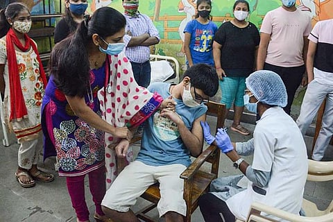 An image of a teenager being administrated vaccine 