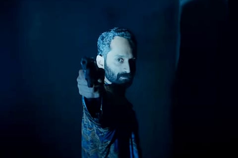 Fahad Faasil is seen holding a gun in the screengrab from the trailer of 'Irul'.