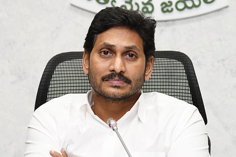 File photo of Jagan Mohan Reddy seated in front of a mic and looking into the distance