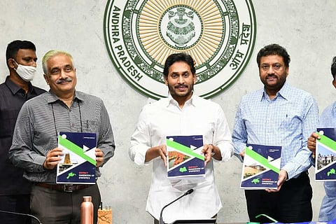 Andhra Pradesh CM Jagan and officials with the District Handbook of Statistics after launching 13 new districts