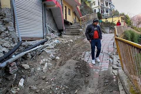 Man standing on the ruins of Joshimath