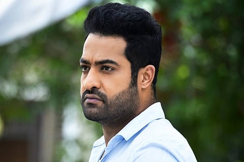 Jr NTR is seen donning a blue shirt and the actor's side profile has been captured in the image. 