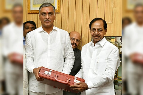 CM KCR and Harish Rao posing with the briefcase of budget documents