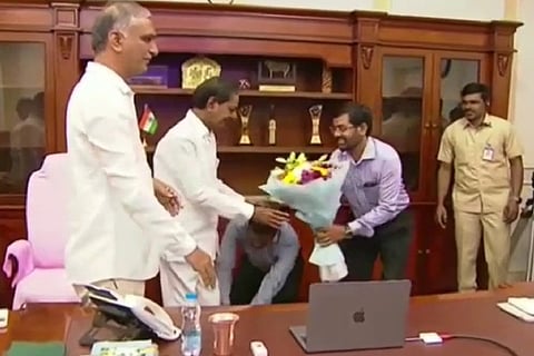 State director of public health G Srinivas Rao touching the feet of the Chief Minister
