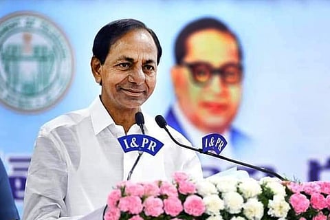 CM KCR smiling while addressing a public gathering