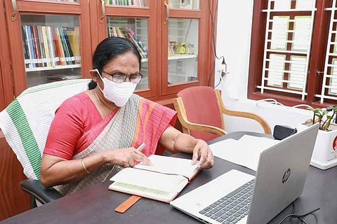 KK Shailaja teacher wearing a mask and sitting in her office