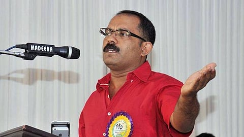 Image of KM Shaji speaking before a mic