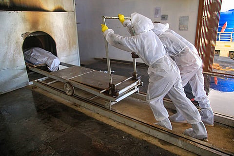 A deadbody being dragged into an electric creamtorium furnace in Kanyakumari