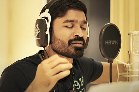 An image of Dhanush  singing  'Thattan Thattan' song from 'Karnan'.