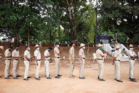 Representative image for Karnataka PSI exam scam: Police officials standing in a queue