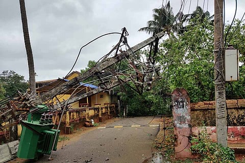 A damaged and uprooted electric poll due to Cyclone Tuktae in coastal Karnataka