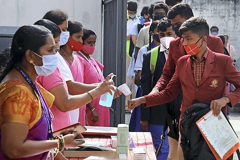 Students getting their hands sanitised before writing board exams at a Karnataka school