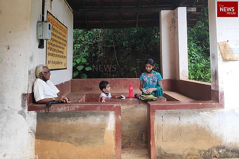 A girl, a boy and an old man in a bus stop