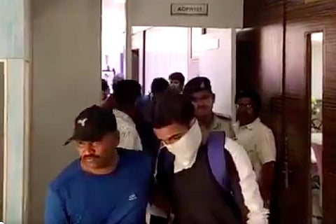 Man wearing mask being arrested