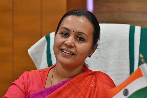 Kerala Health Minister Veena George sitting on her desk