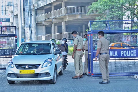 Police officials checking a passing car during lockdown