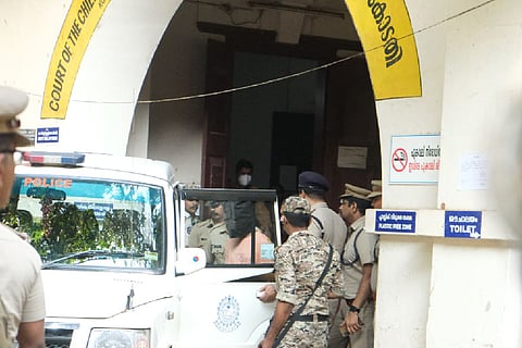 The accused being taken by the police 