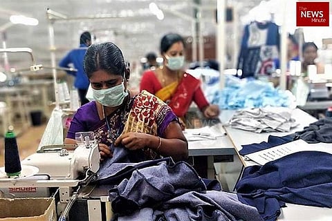 Garment workers seen operating a sewing machine