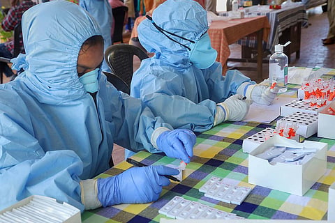 Healthcare workers take COVID-19 samples for testing