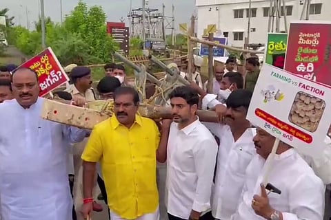 Lokesh and other TDP leaders dragging a bullock cart to the Assembly 