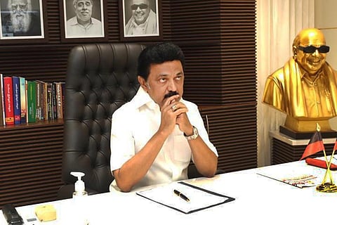 Tamil Nadu Chief Minister MK Stalin sitting at his desk with his elbows resting on the table