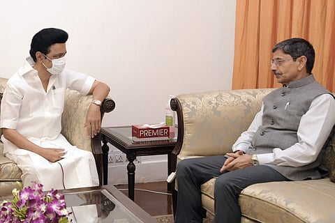 Chief Minister MK Stalin sits on the left wearing a mask as Governor RN Ravi sits on the right facing him