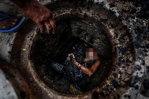 A person cleaning inside a tank