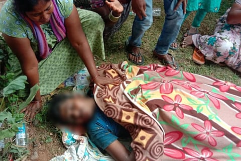 The dead body of Shiva covered in a blanket 