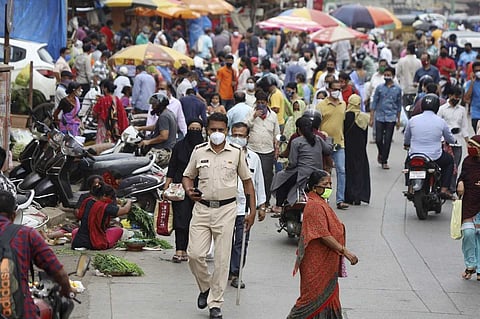 A crowd of people at a marketplace during pandemic