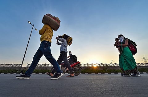 A file photo of migrant workers walking home amid the coronavirus pandemic