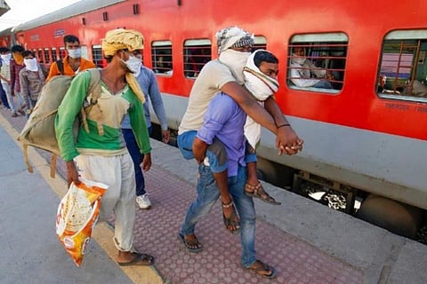 Migrant workers at a railway station platform