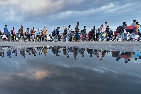 Migrant workers walking home amid the nationwide lockdown in March. 