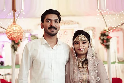 Mofiya Parveen and Muhammed Suhail in wedding finery at their wedding ceremony