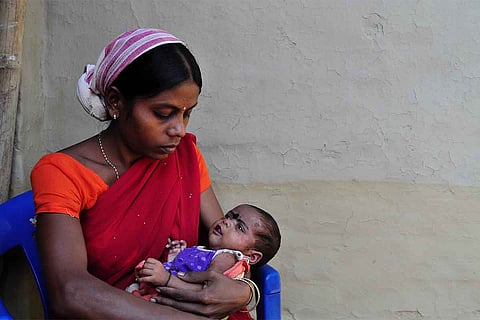 A mother holding her baby