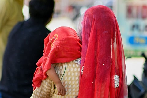 Representative of a mother and child with their heads covered with a cloth