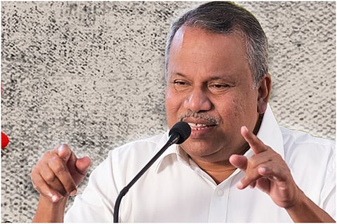 Kerala CPI Leader and Former Minister Mullakkara Retnakaran Speaking, facing a mike 
