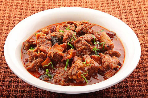 Mutton curry in a big white bowl 