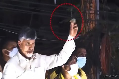 Chandrababu Naidu showing the stone to the crowd at the roadshow