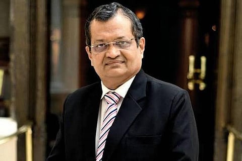 Man posing in glasses and a suit 