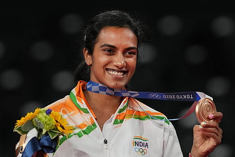  India's Pusarla V Sindhu poses for photographs while standing on the podium after receiving the bronze medal in women's singles badminton event at the Summer Olympics 2020, in Tokyo, Sunday, August 1, 2021