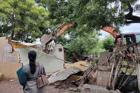 A house being demolished for Cooum eco-restoration project in Padikuppam area of Mogappair