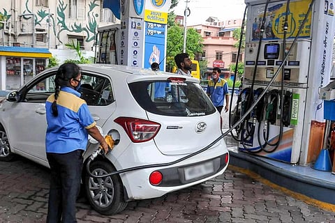 An employee fills in a vehicle at a filling station
